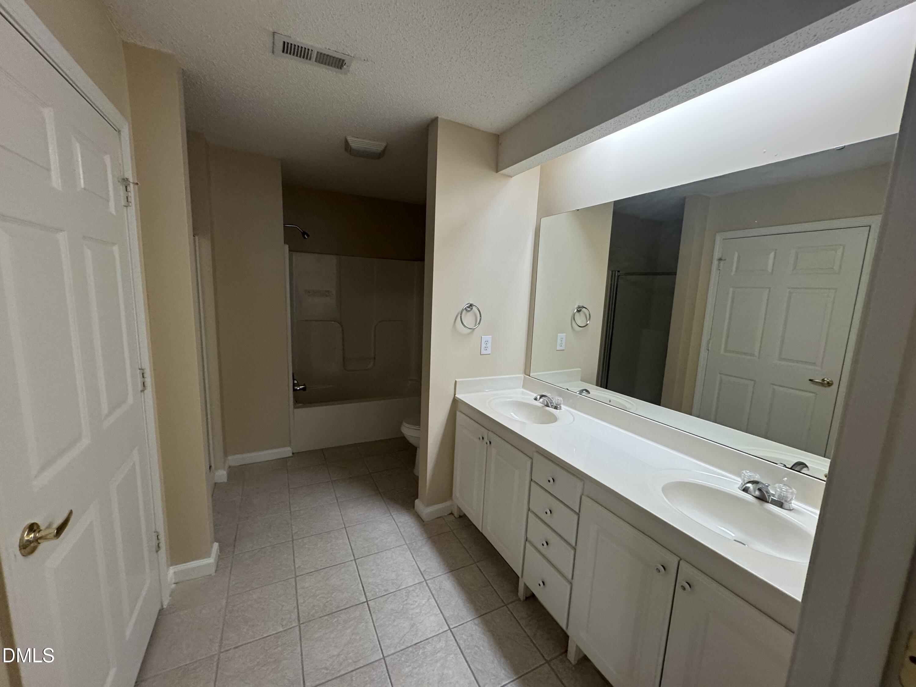 Undisclosed Address Raleigh, NC 27617 - Photo 18 of 22 a bathroom with a double vanity sink and mirror