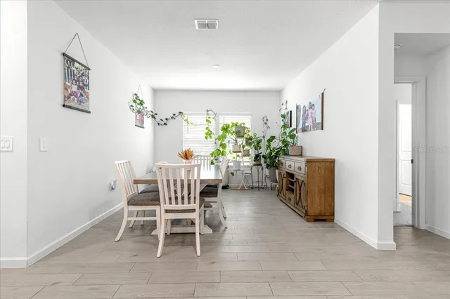 a dining room with furniture and a chandelier