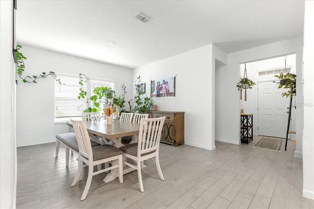 a view of a dining room with furniture and a potted plant