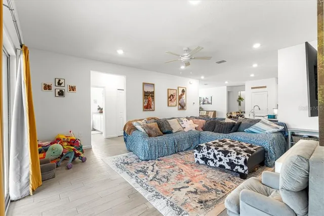 a large bedroom with furniture and a window