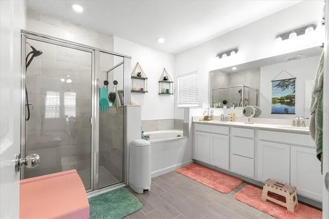 a bathroom with a double vanity sink mirror and shower