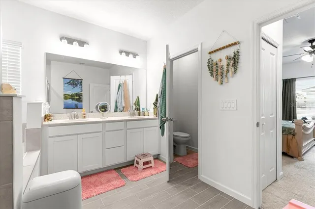 a spacious bathroom with a sink mirror and shower