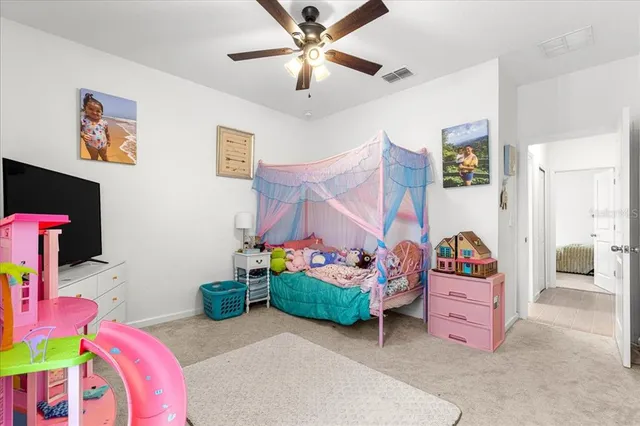 a bedroom with bed and a chandelier