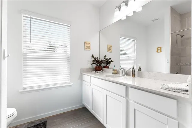 a kitchen with a sink cabinets and a window