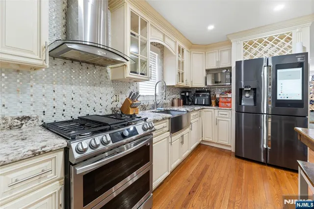 a kitchen with a stove a refrigerator and a sink