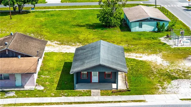 a view of a backyard with plants and a lake view