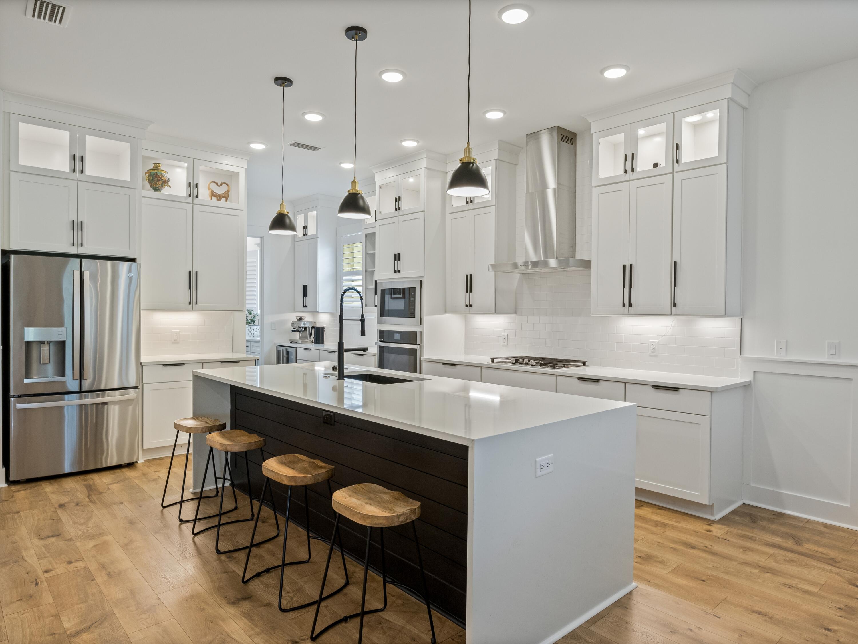 298 Lafayette Road Watersound, FL 32461 - Photo 19 of 76 a kitchen with stainless steel appliances granite countertop a sink a stove a refrigerator and chairs