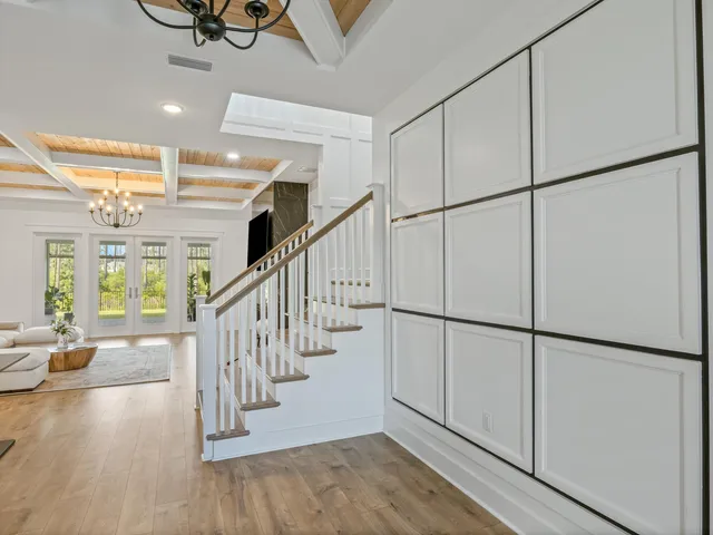 a view of entryway and hall with wooden floor