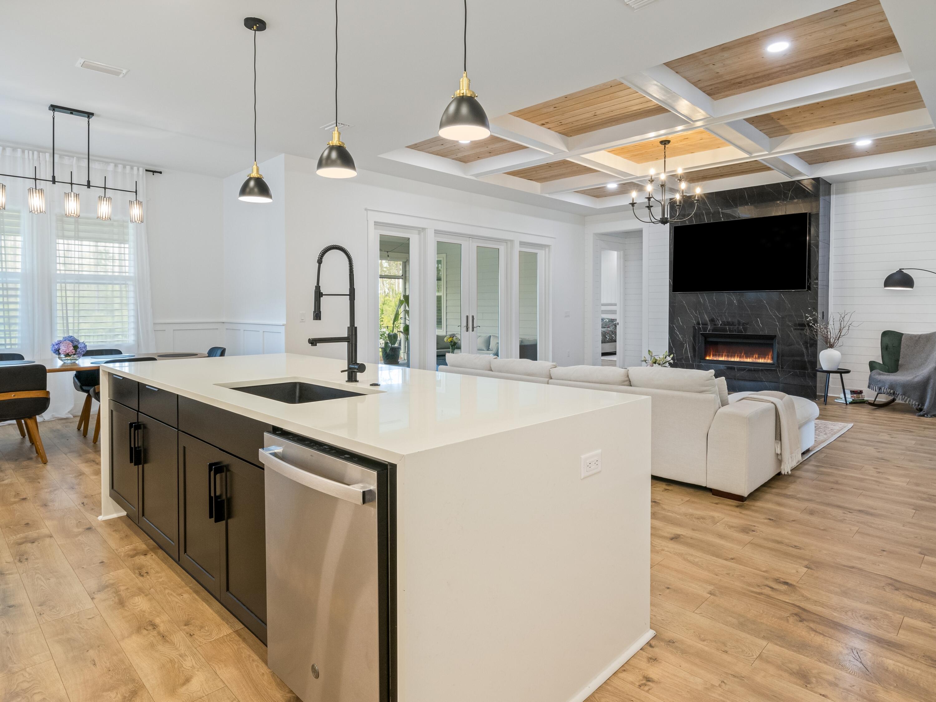 298 Lafayette Road Watersound, FL 32461 - Photo 24 of 76 a kitchen with stainless steel appliances granite countertop a sink a stove and a wooden floors