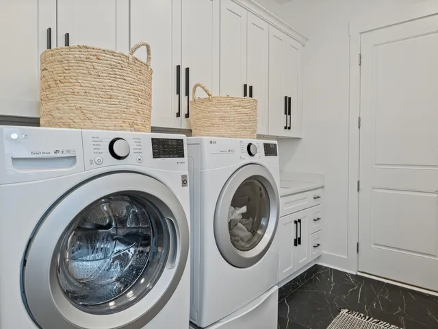 a bedroom with a bed and a flat tv screen on dresser