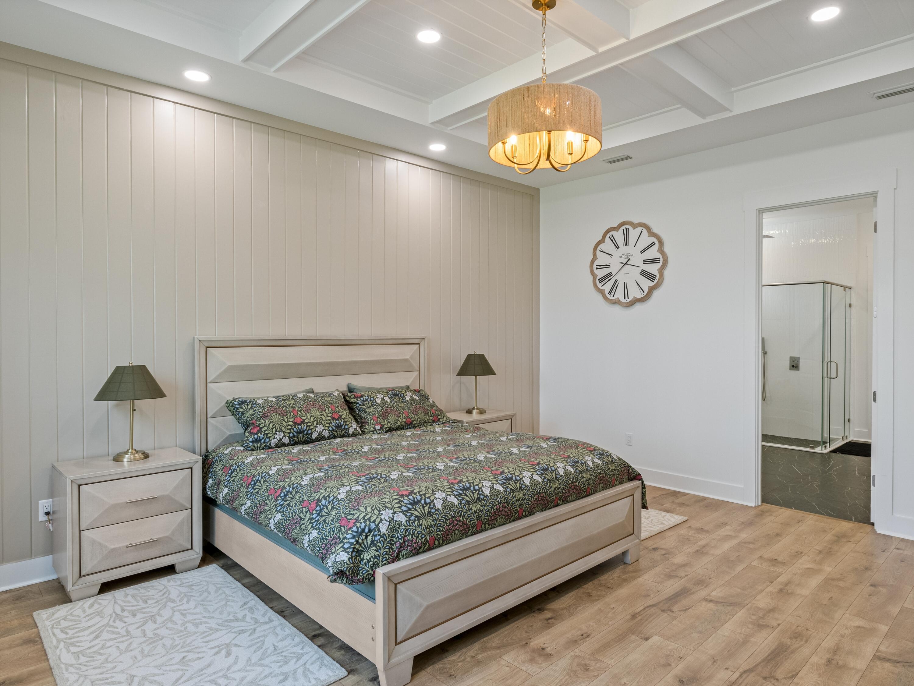 298 Lafayette Road Watersound, FL 32461 - Photo 32 of 76 a bedroom with a bed and a chandelier