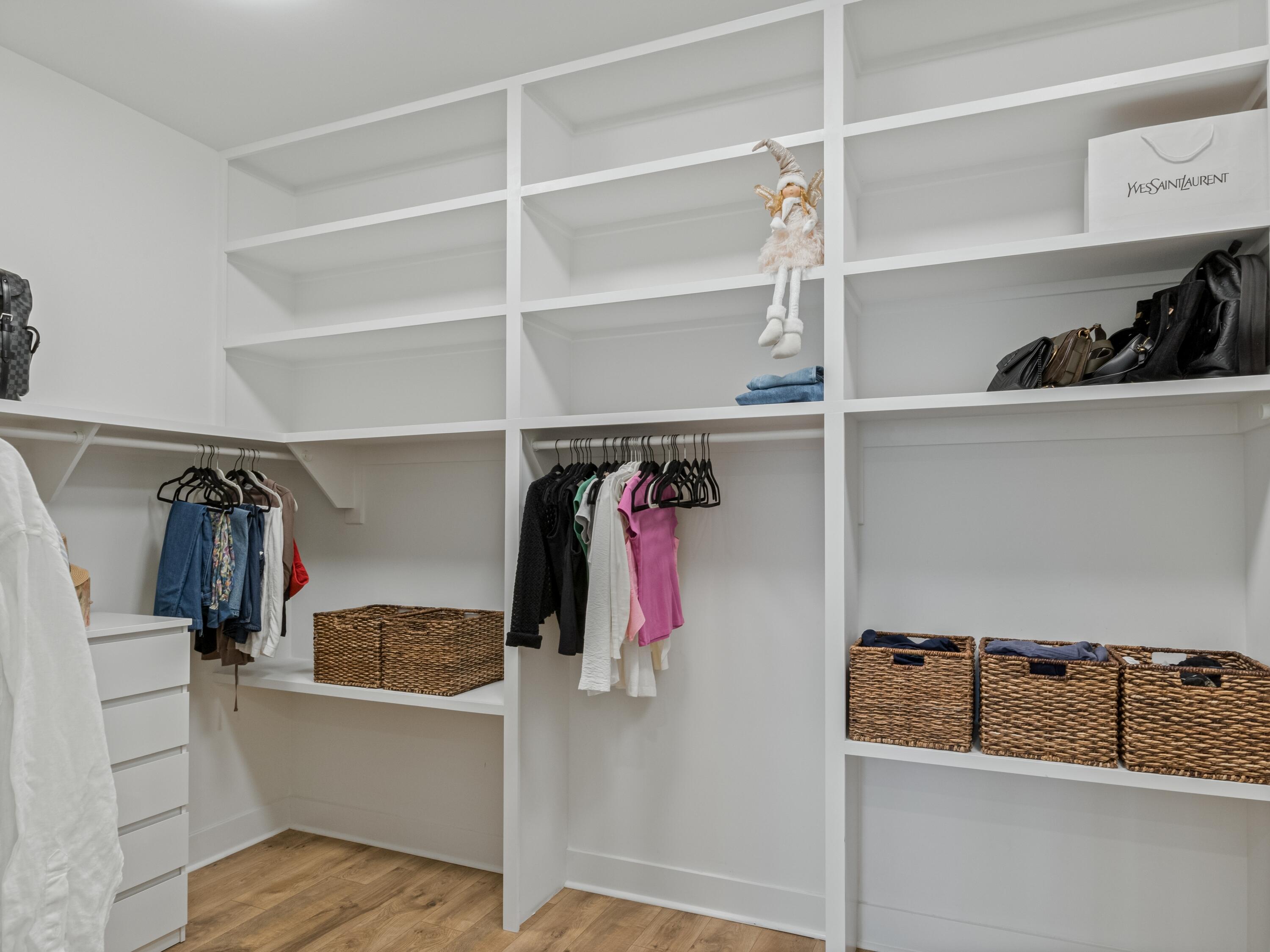 298 Lafayette Road Watersound, FL 32461 - Photo 35 of 76 a view of walk in closet with clothes and shoes