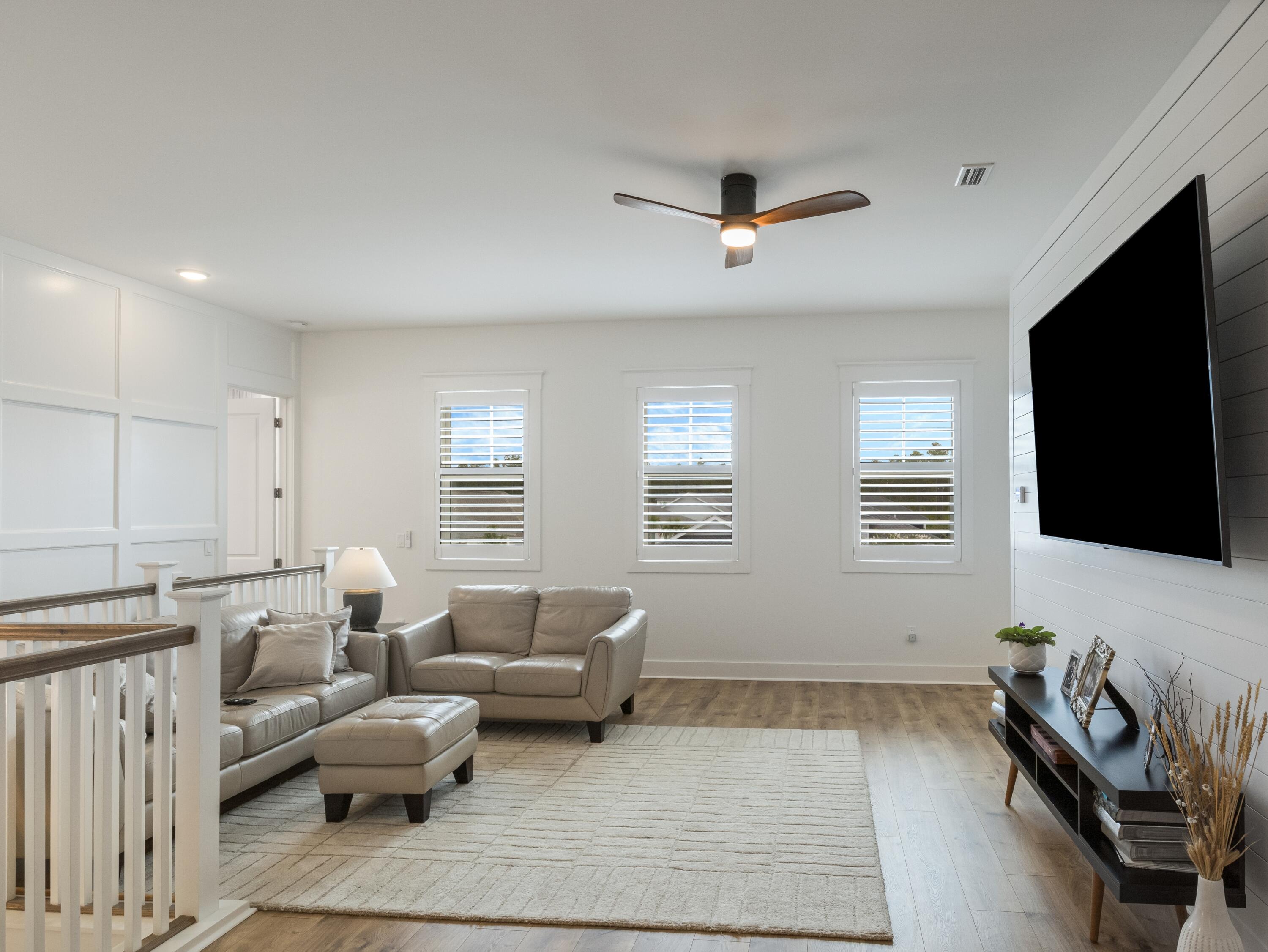 298 Lafayette Road Watersound, FL 32461 - Photo 41 of 76 a living room with furniture and a flat screen tv