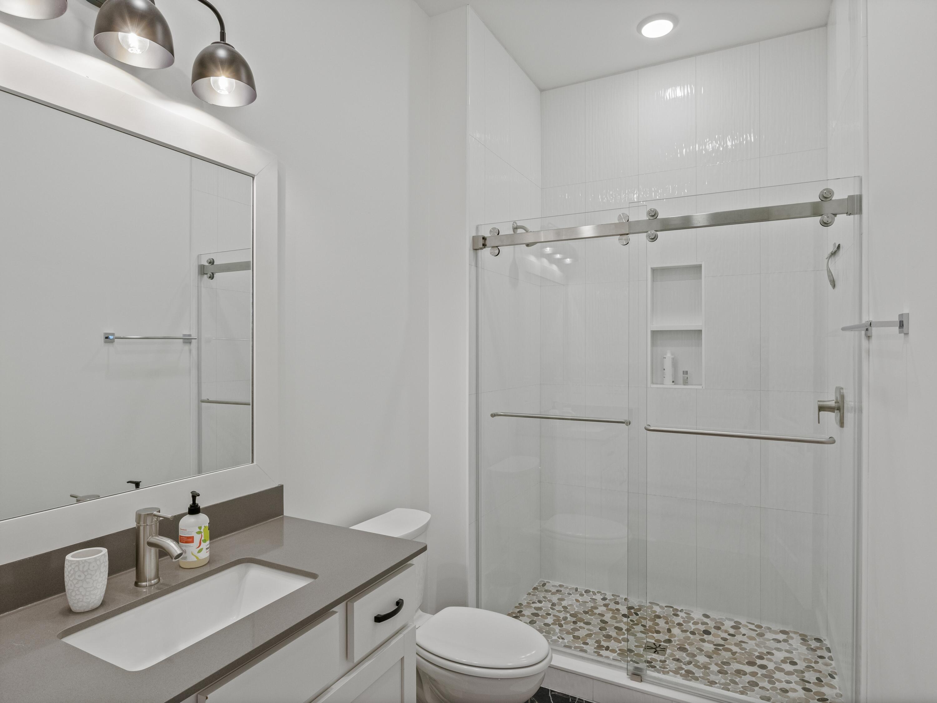 298 Lafayette Road Watersound, FL 32461 - Photo 44 of 76 a bathroom with a sink a toilet and shower