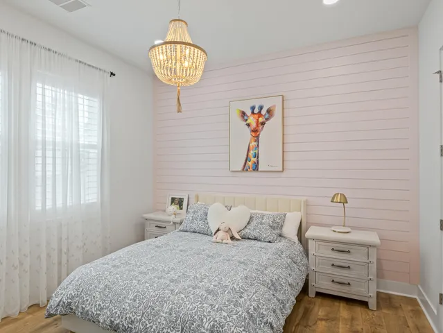 a view of a house with a palm tree and a yard