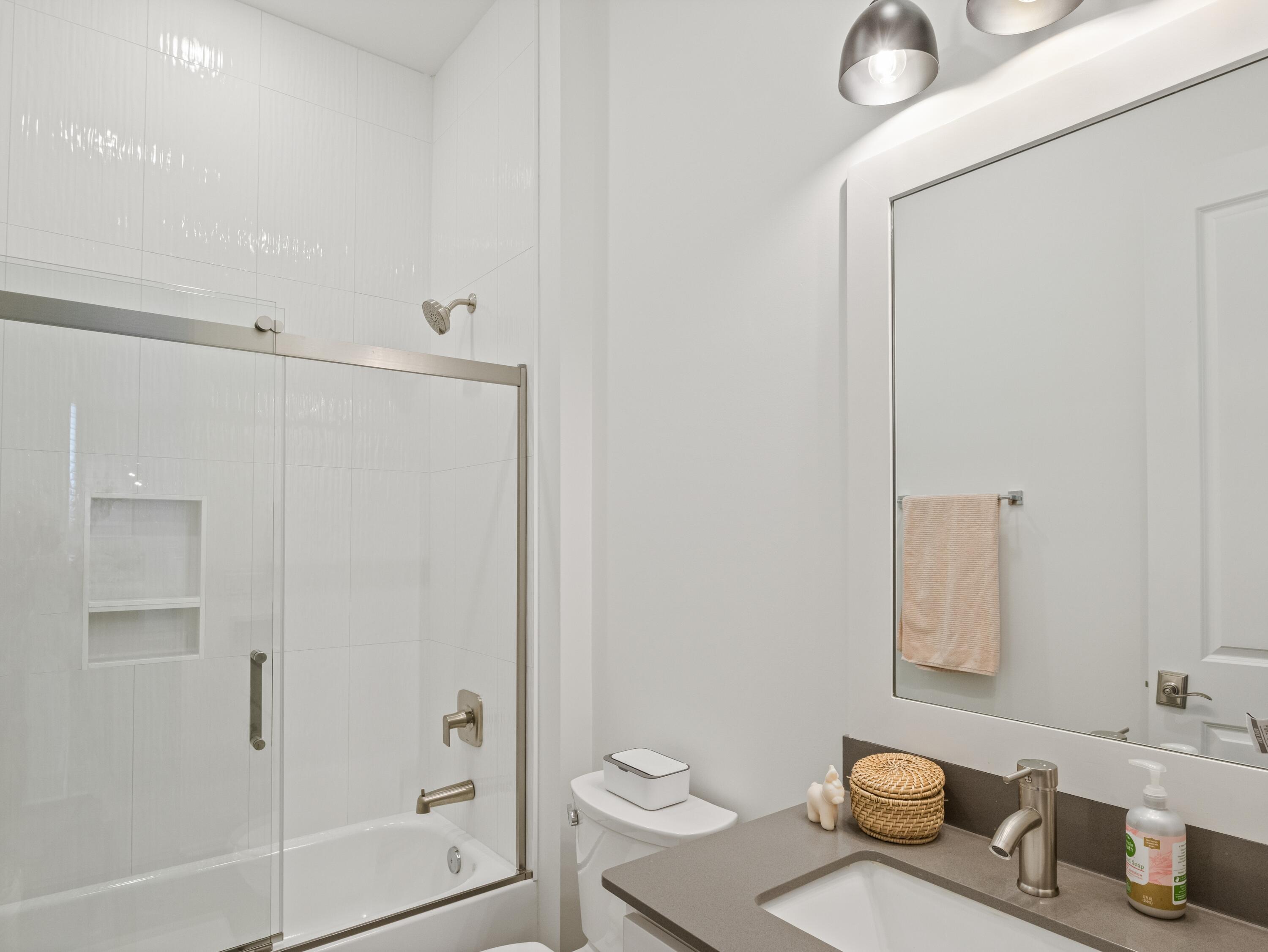 298 Lafayette Road Watersound, FL 32461 - Photo 47 of 76 a bathroom with a granite countertop sink a toilet and shower