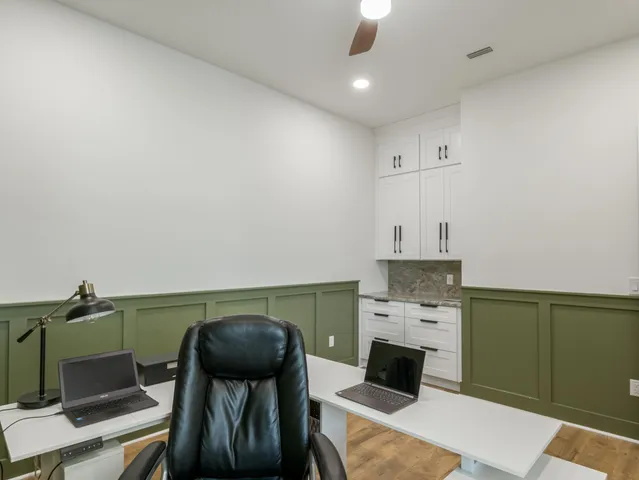 a view of a hallway with wooden floor and closet