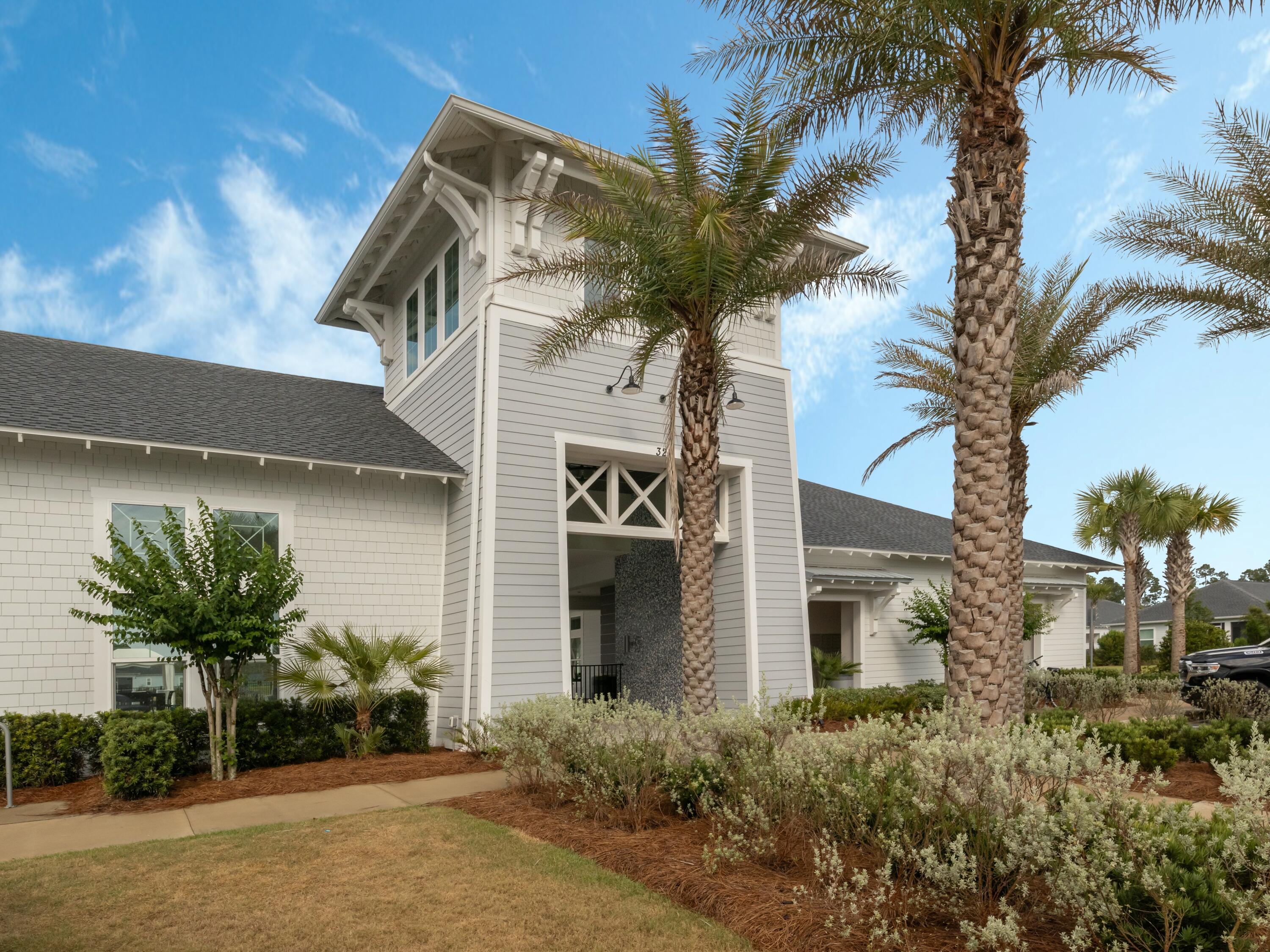 298 Lafayette Road Watersound, FL 32461 - Photo 69 of 76 a view of a house with a palm tree and a yard