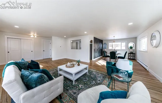 a living room with furniture and wooden floor