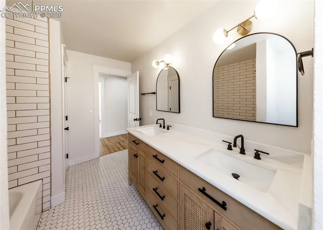 a bathroom with a double vanity sink and mirror