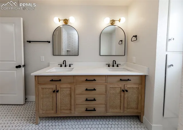 a bathroom with a double vanity sink and mirror