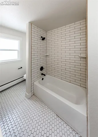 a bathroom with a bathtub and a shower