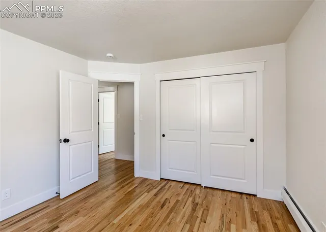 a view of a room with wooden floor