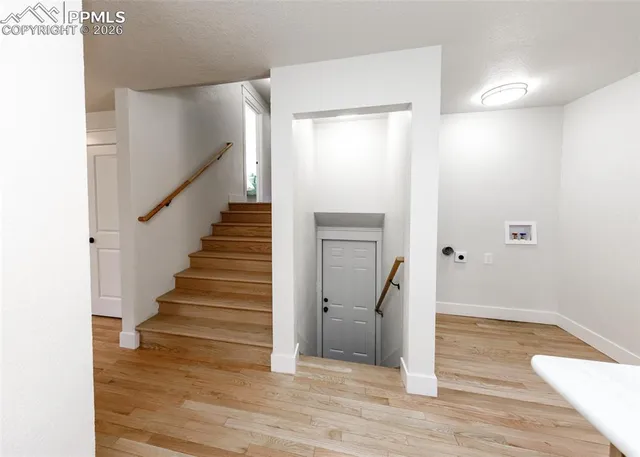 a view of entryway and hall with wooden floor