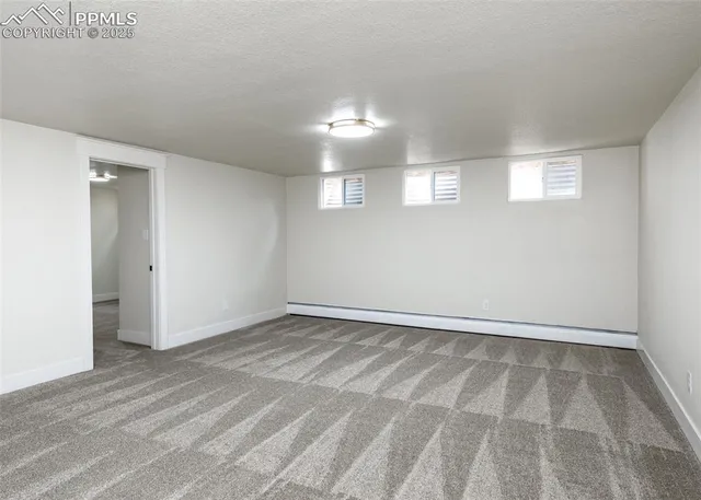 a view of an empty room and a window