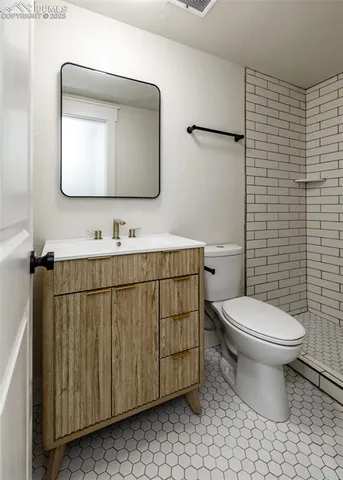 a bathroom with a toilet and a shower