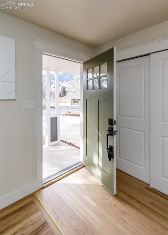 a view of a big room with wooden floor and windows