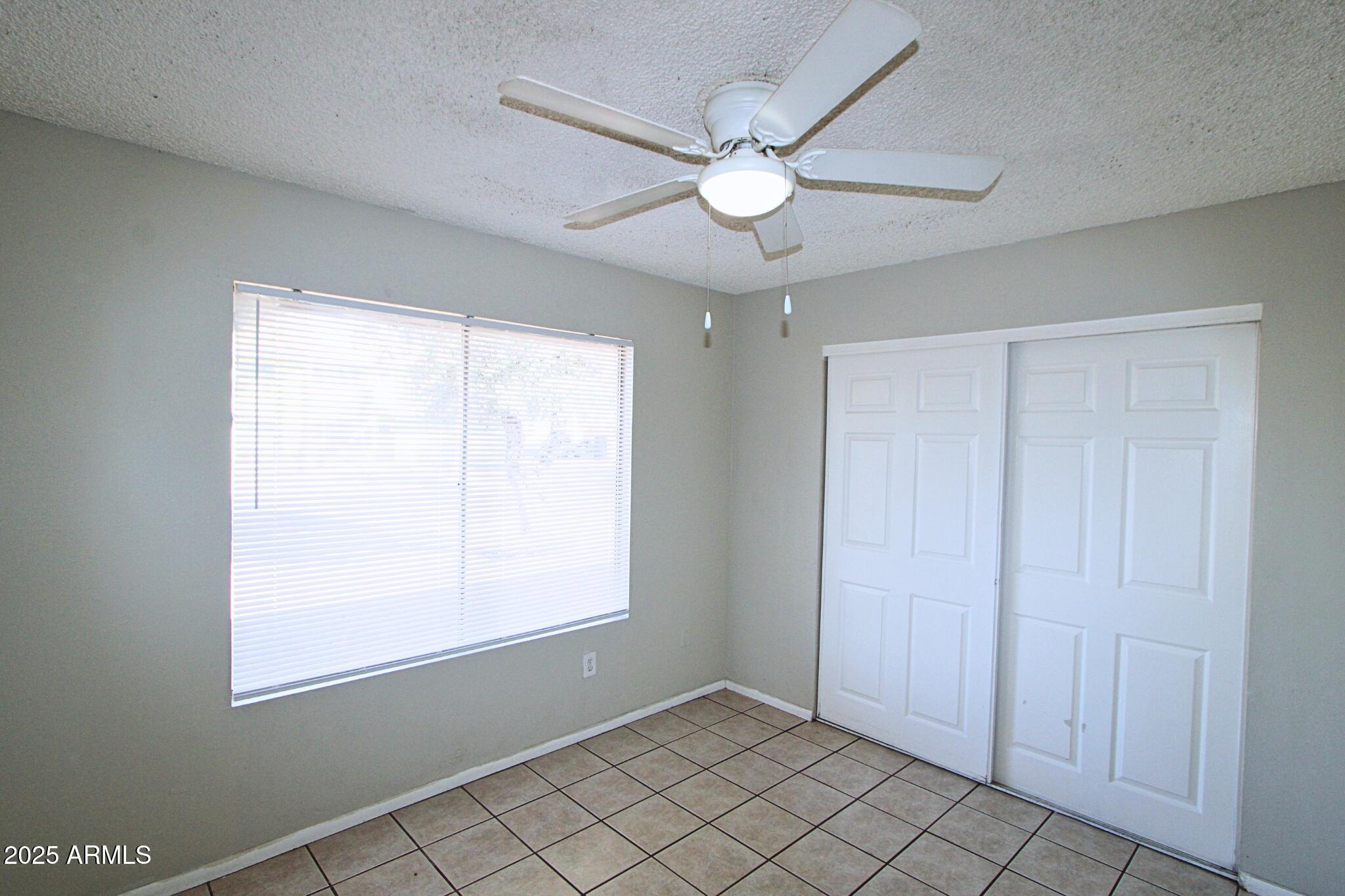 3313 West Harmont Drive, Unit 1 Phoenix, AZ 85051 - Photo 13 of 16 a view of an empty room with a window