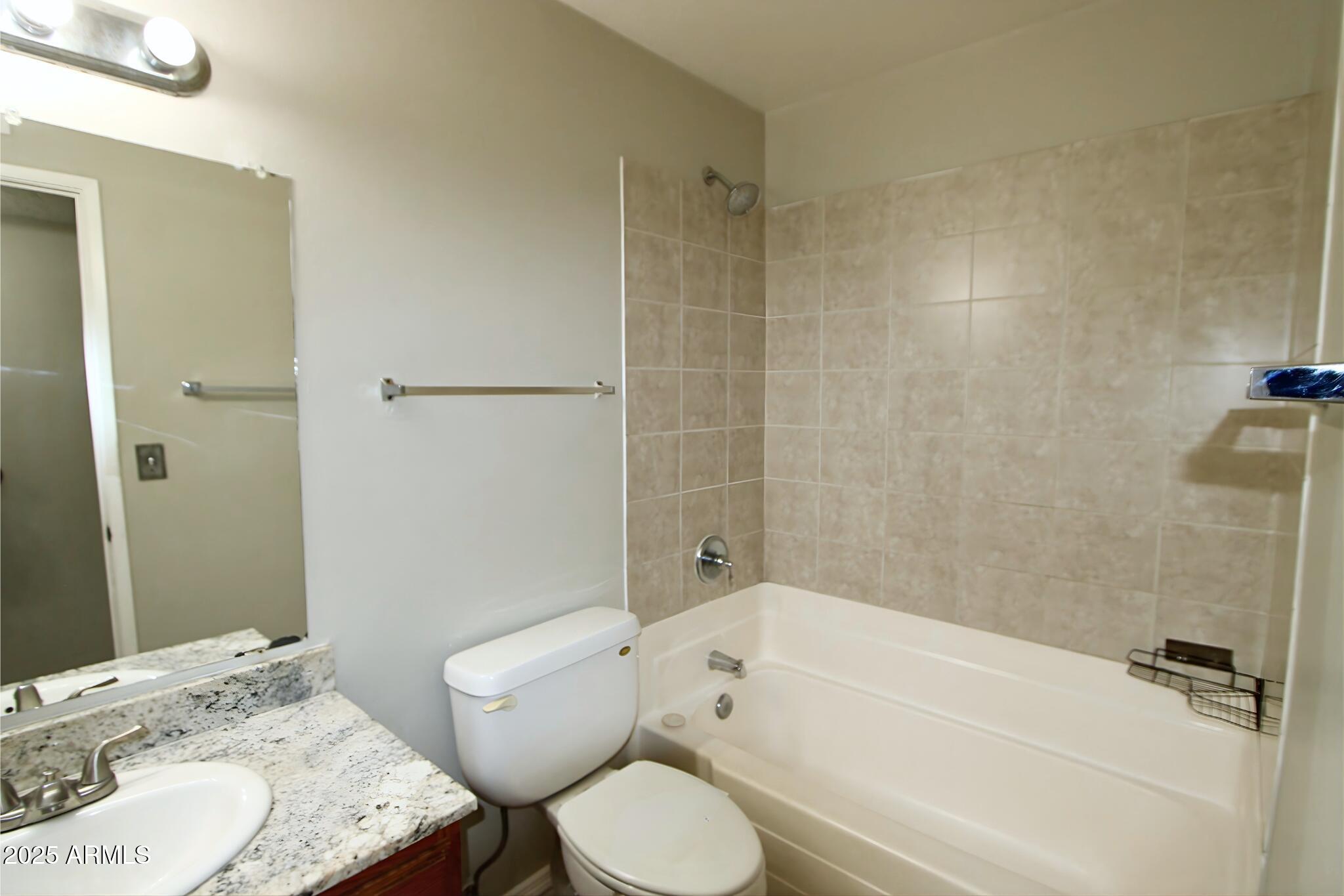 3313 West Harmont Drive, Unit 1 Phoenix, AZ 85051 - Photo 14 of 16 a bathroom with a sink toilet and shower