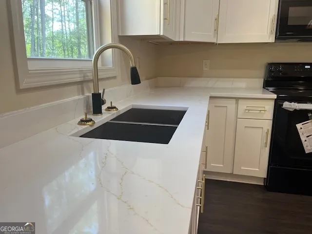 a kitchen with a sink and a stove