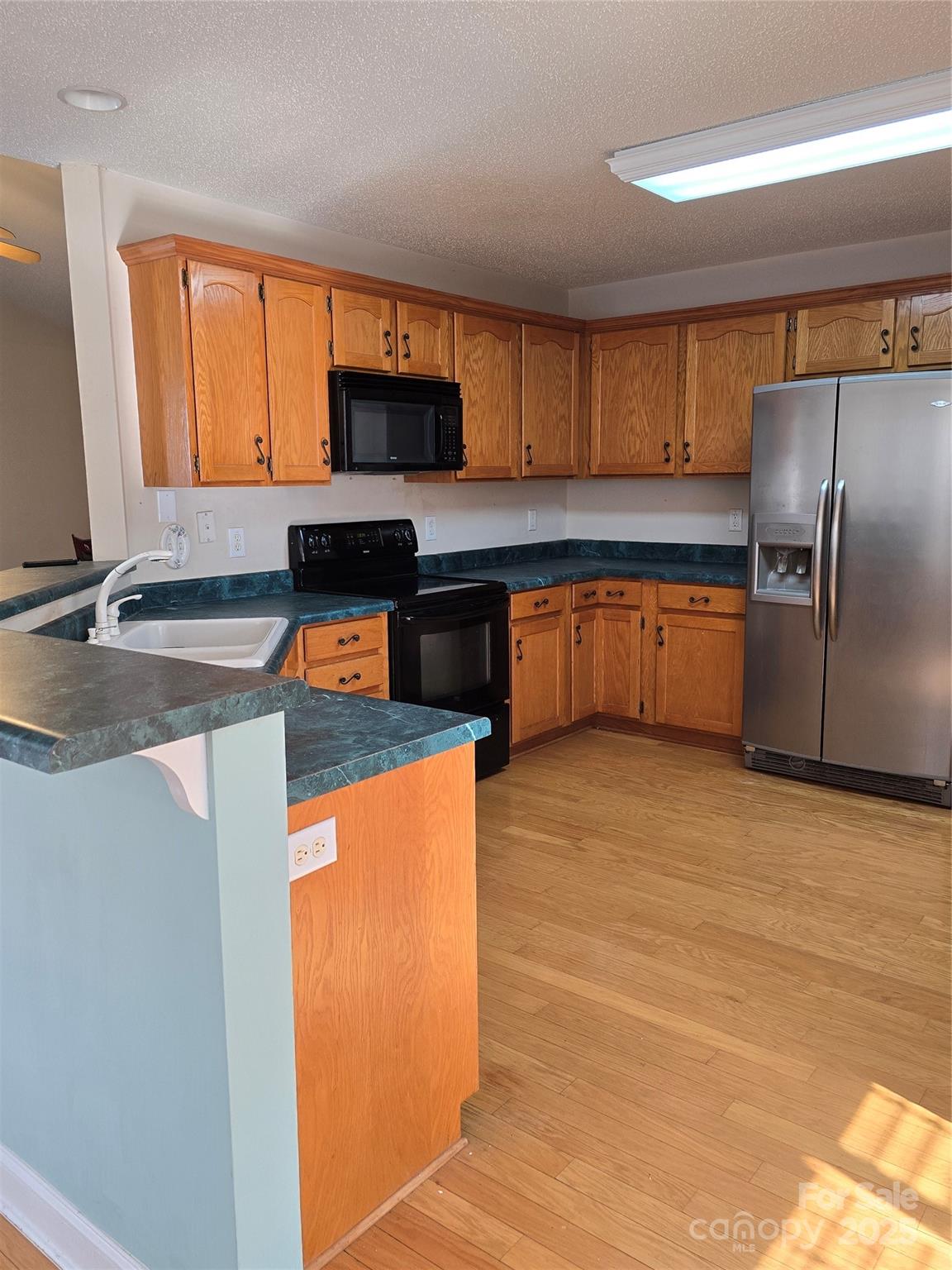 462 Cress Loop Road Salisbury, NC 28147 - Photo 13 of 48 a kitchen with stainless steel appliances granite countertop a sink refrigerator and microwave