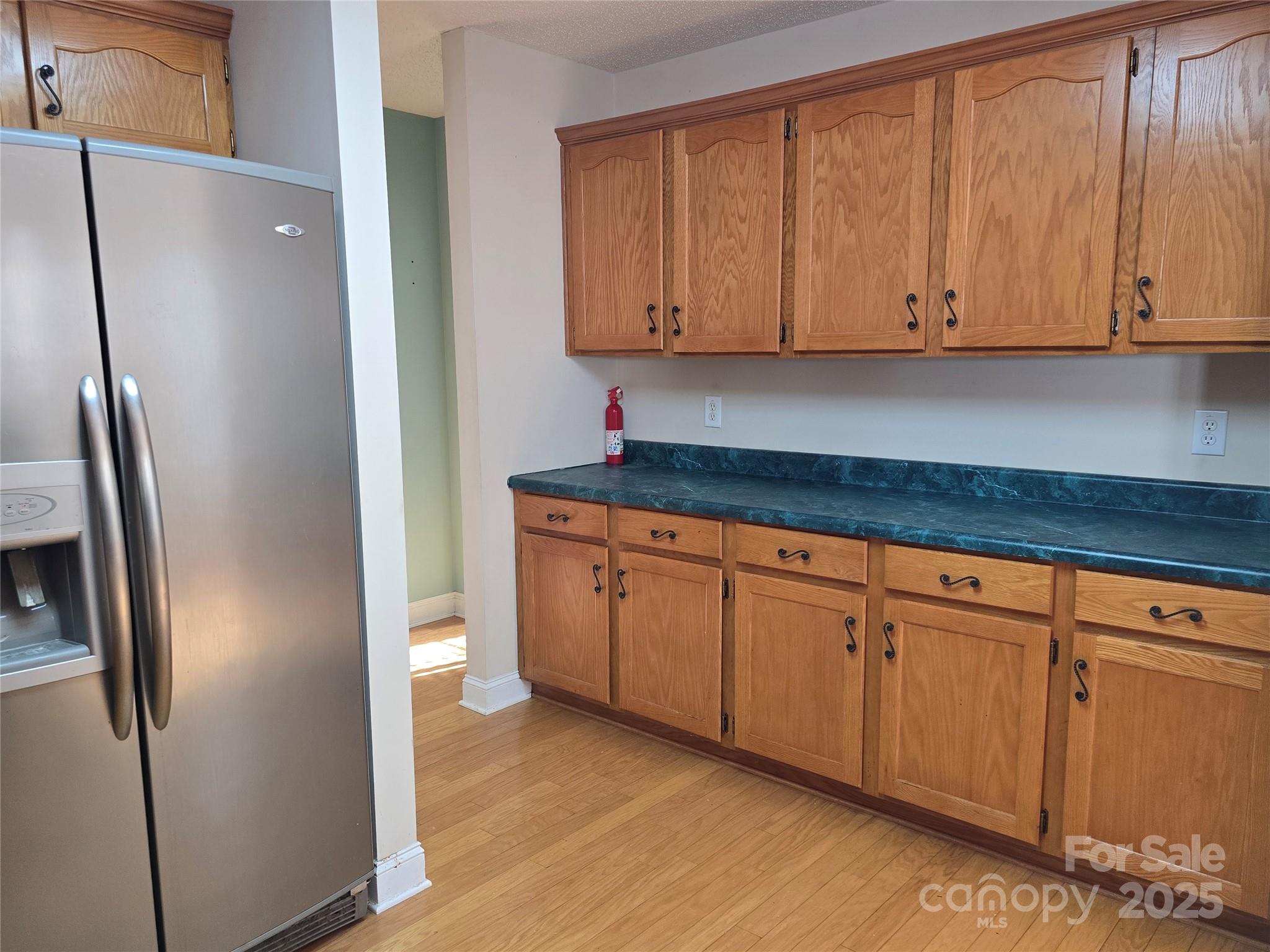 462 Cress Loop Road Salisbury, NC 28147 - Photo 15 of 48 a kitchen with stainless steel appliances granite countertop a refrigerator a microwave and cabinets