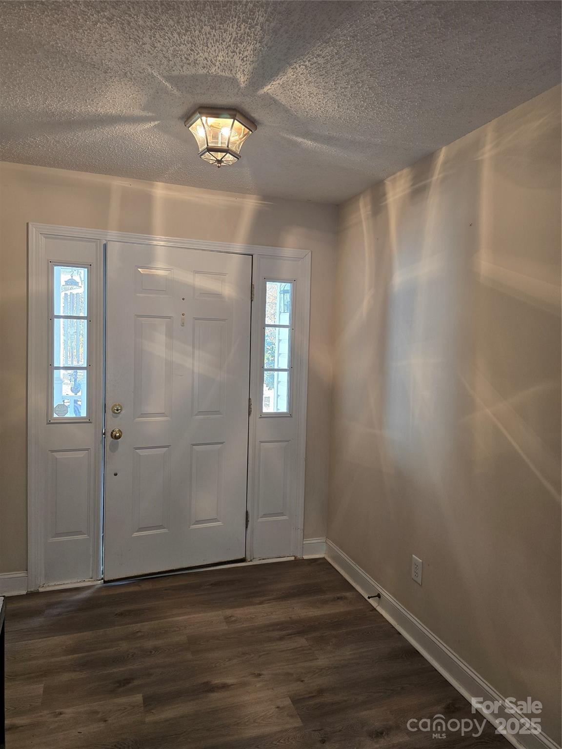 462 Cress Loop Road Salisbury, NC 28147 - Photo 5 of 48 a view of an empty room with wooden floor and a window