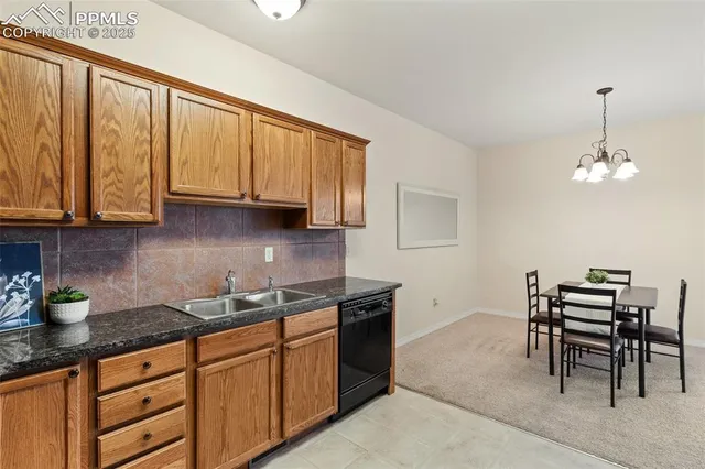 a kitchen with stainless steel appliances granite countertop a stove a sink dishwasher and cabinets with wooden floor