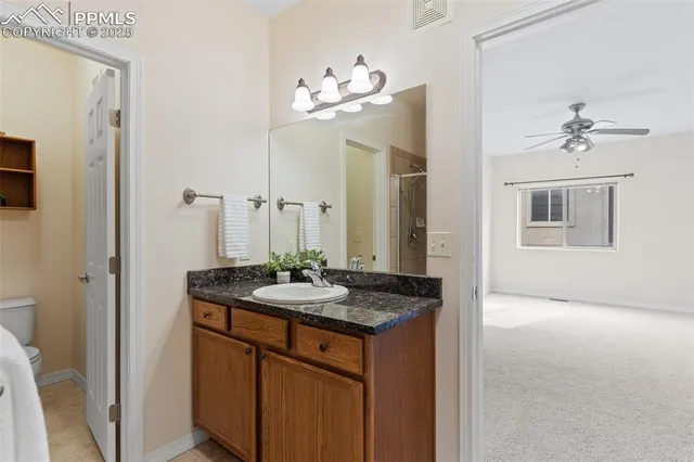 a bathroom with a granite countertop sink a mirror and a vanity