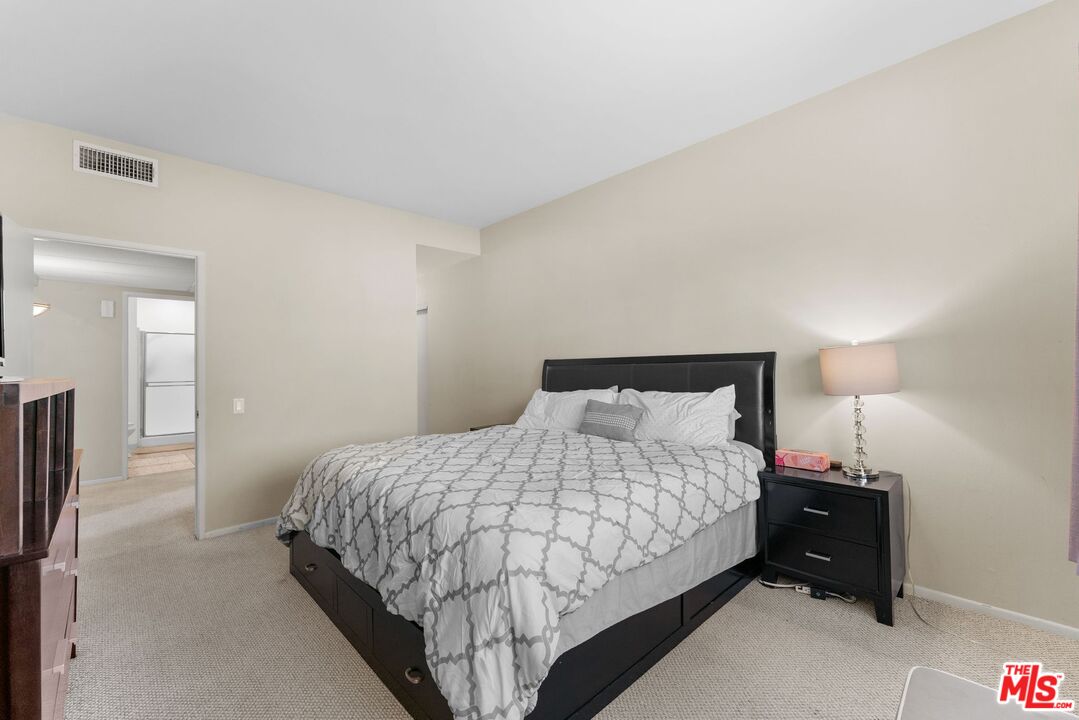 612 South Barrington Avenue, Unit 317 Los Angeles, CA 90049 - Photo 11 of 17 a bedroom with a bed and a night stand