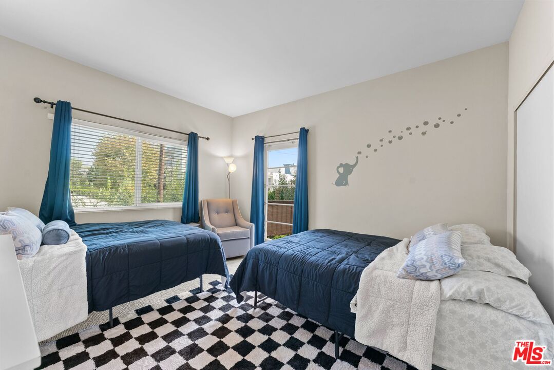 612 South Barrington Avenue, Unit 317 Los Angeles, CA 90049 - Photo 13 of 17 a bedroom with two beds and a window