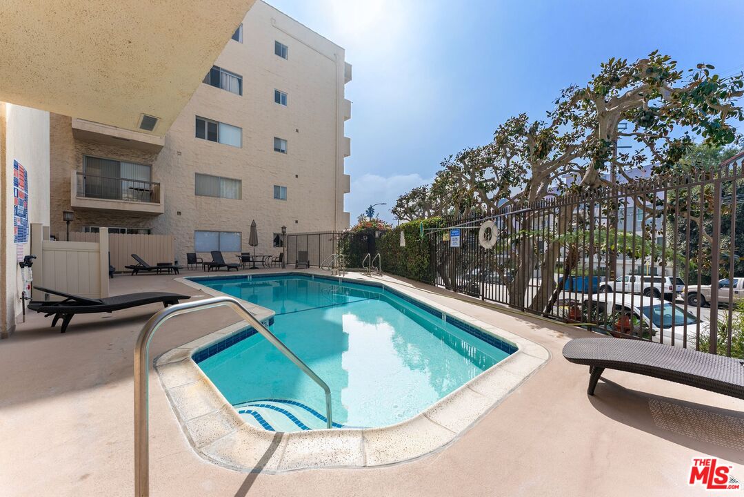 612 South Barrington Avenue, Unit 317 Los Angeles, CA 90049 - Photo 17 of 17 a view of a swimming pool with a patio