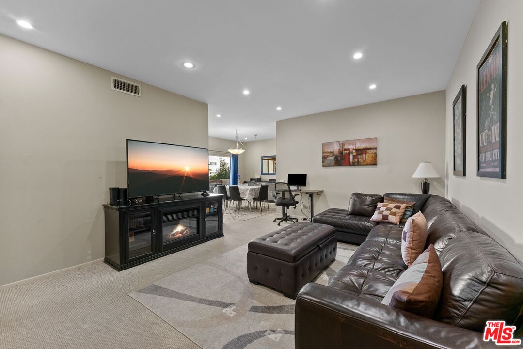 612 South Barrington Avenue, Unit 317 Los Angeles, CA 90049 - Photo 5 of 17 a living room with furniture and a flat screen tv