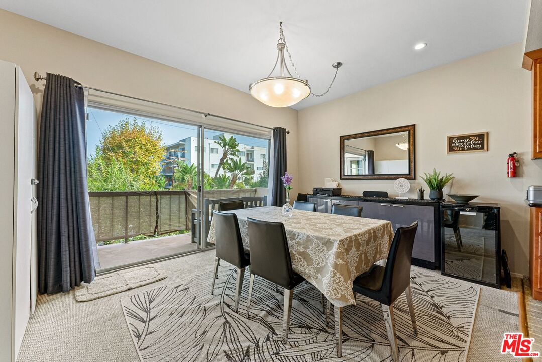 612 South Barrington Avenue, Unit 317 Los Angeles, CA 90049 - Photo 6 of 17 a view of a dining room with furniture window and outside view