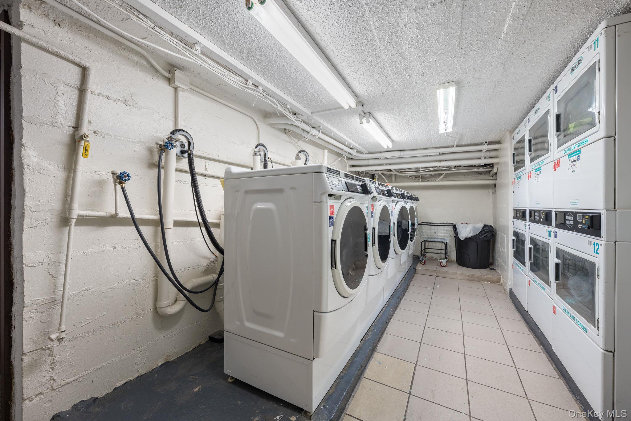 310 Riverside Boulevard, Unit 4K Long Beach, NY 11561 - Photo 9 of 12 a utility room with multiple dryer and washer