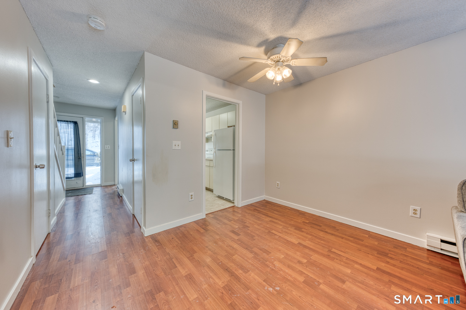 35 Riveredge Drive, Unit 35 Winsted, CT 06098 - Photo 11 of 33 a view of a livingroom with a chandelier fan and wooden floor