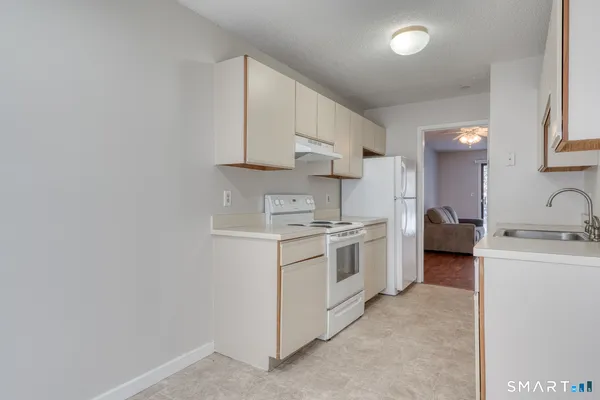 a kitchen with stainless steel appliances granite countertop a sink and cabinets