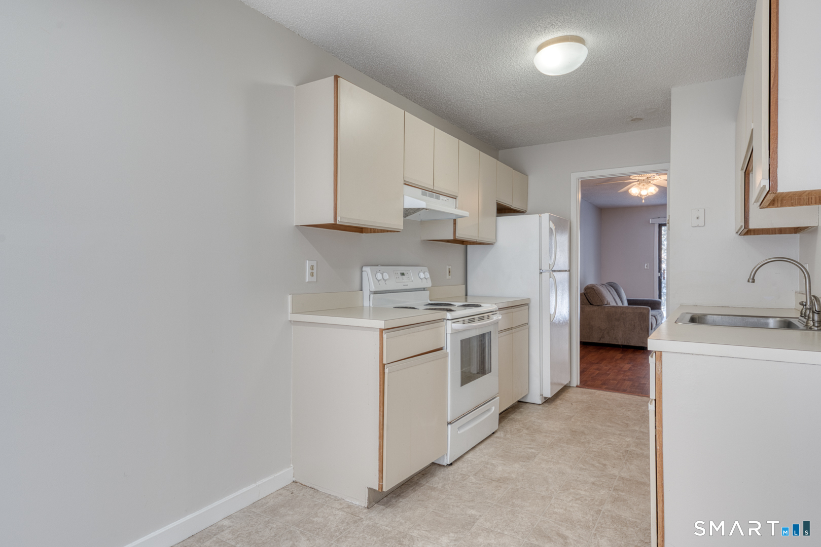 35 Riveredge Drive, Unit 35 Winsted, CT 06098 - Photo 14 of 33 a kitchen with stainless steel appliances granite countertop a sink and cabinets