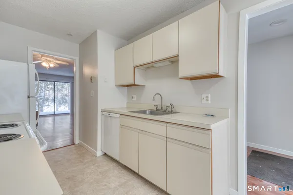 a kitchen with sink and cabinets