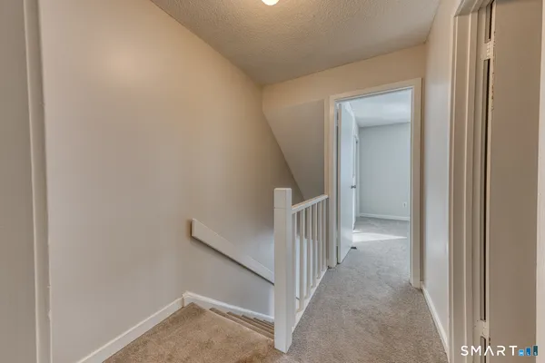 a view of a hallway with a room